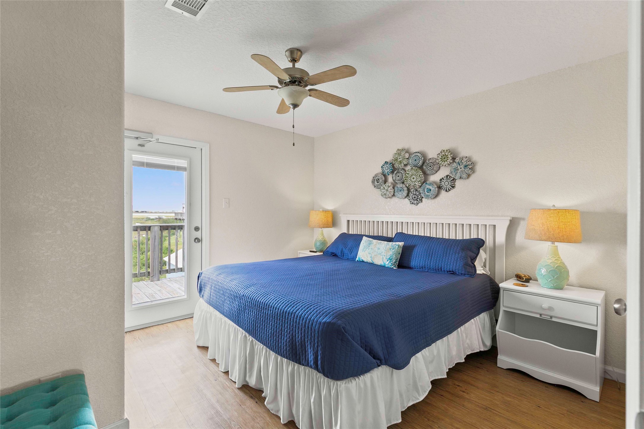 757 Bluewater Highway Surfside Beach, TX 77541 - Photo 23 of 44 a bedroom with a bed a dresser and potted plant