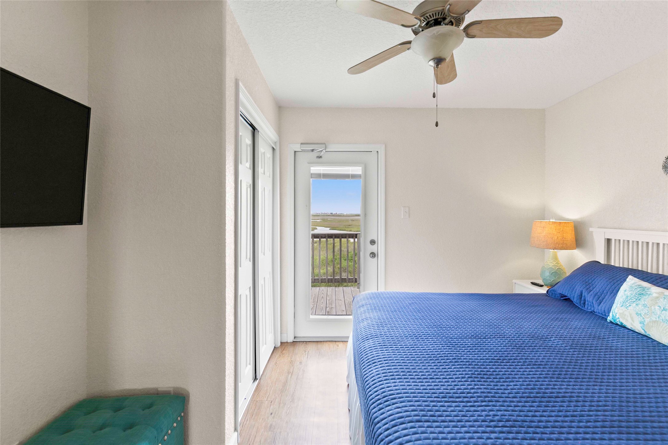 757 Bluewater Highway Surfside Beach, TX 77541 - Photo 24 of 44 a bedroom with a bed and a chandelier