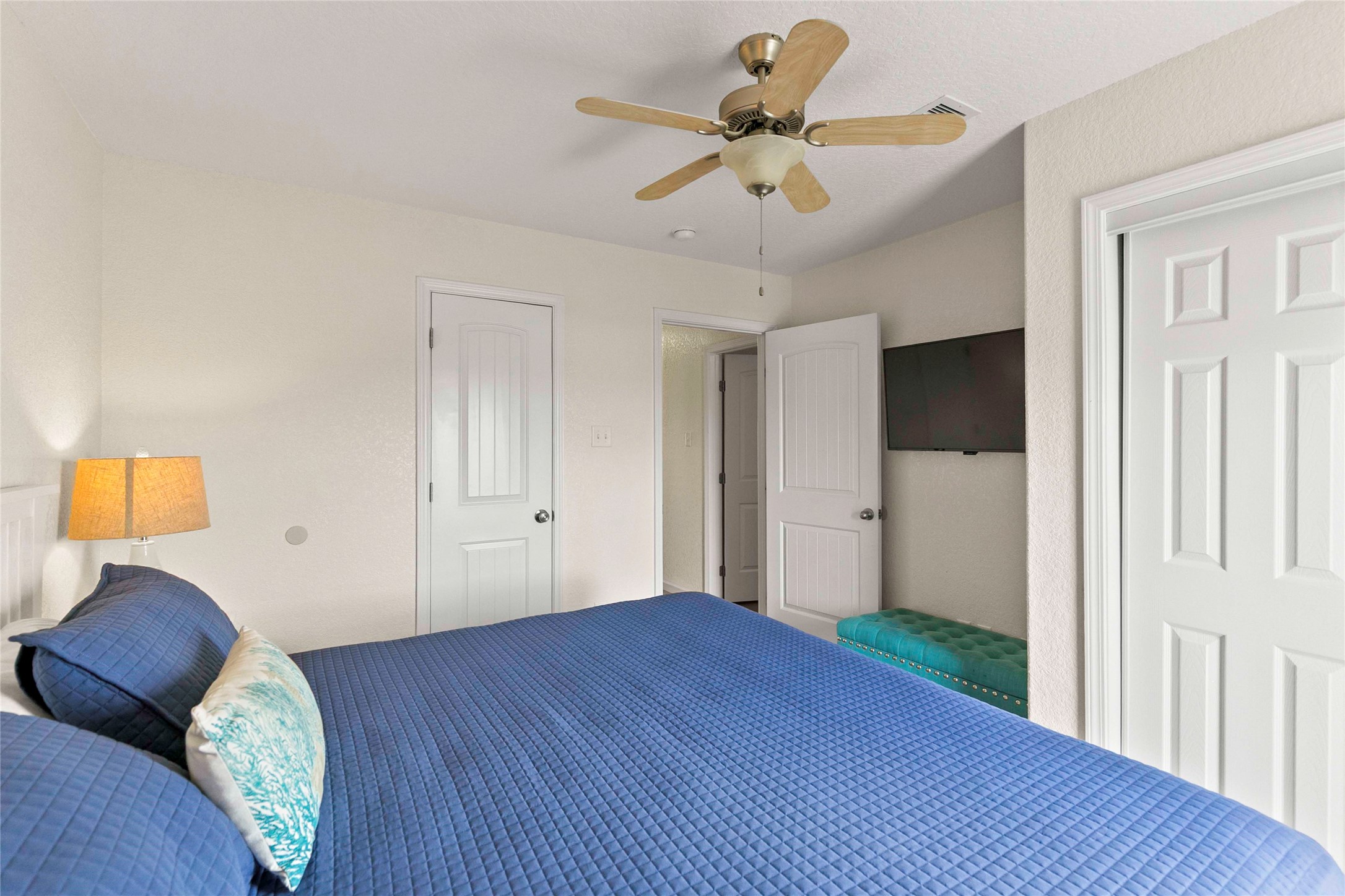 757 Bluewater Highway Surfside Beach, TX 77541 - Photo 25 of 44 a view of a bedroom with wooden floor and a ceiling fan