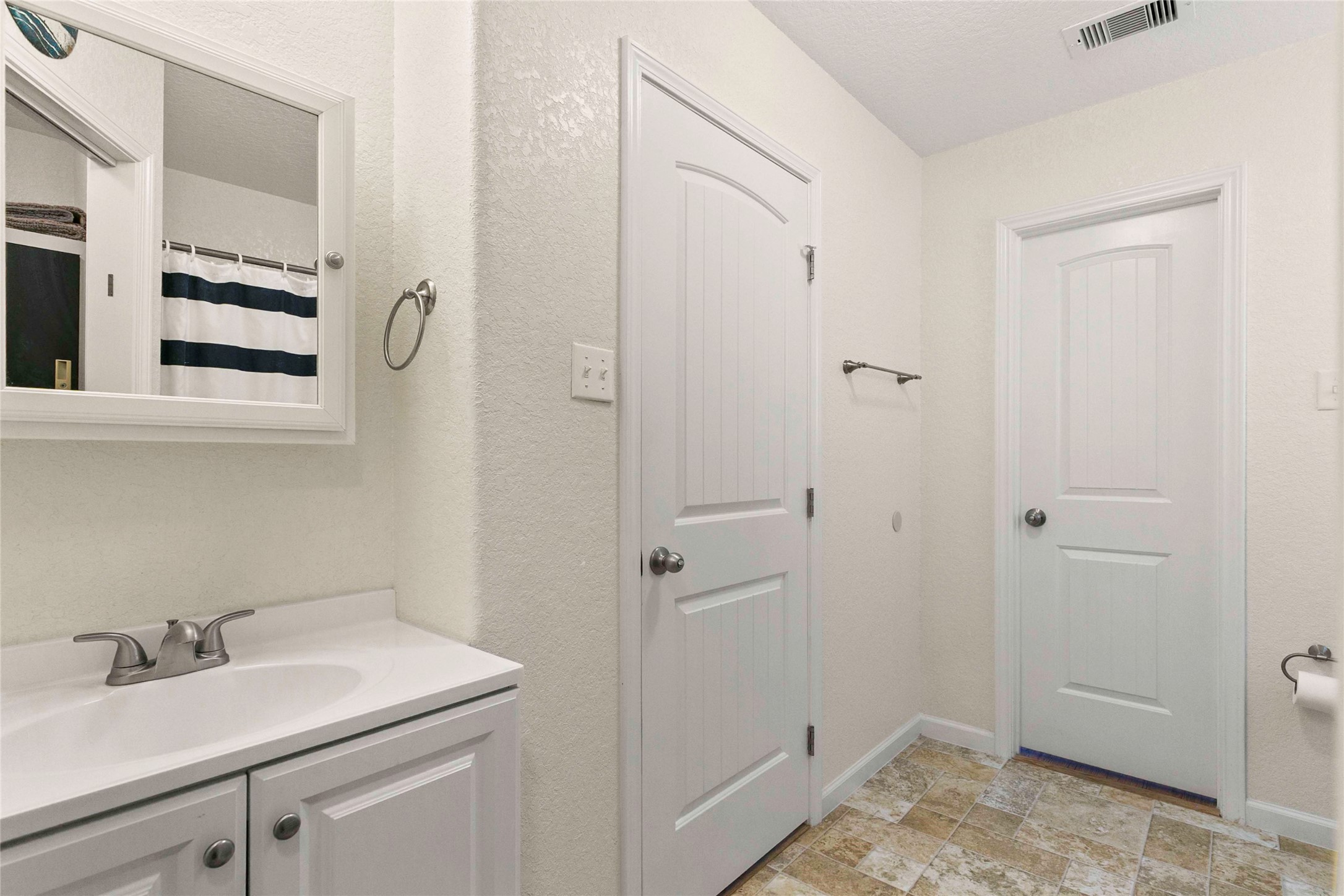 757 Bluewater Highway Surfside Beach, TX 77541 - Photo 26 of 44 a bathroom with a sink and a mirror