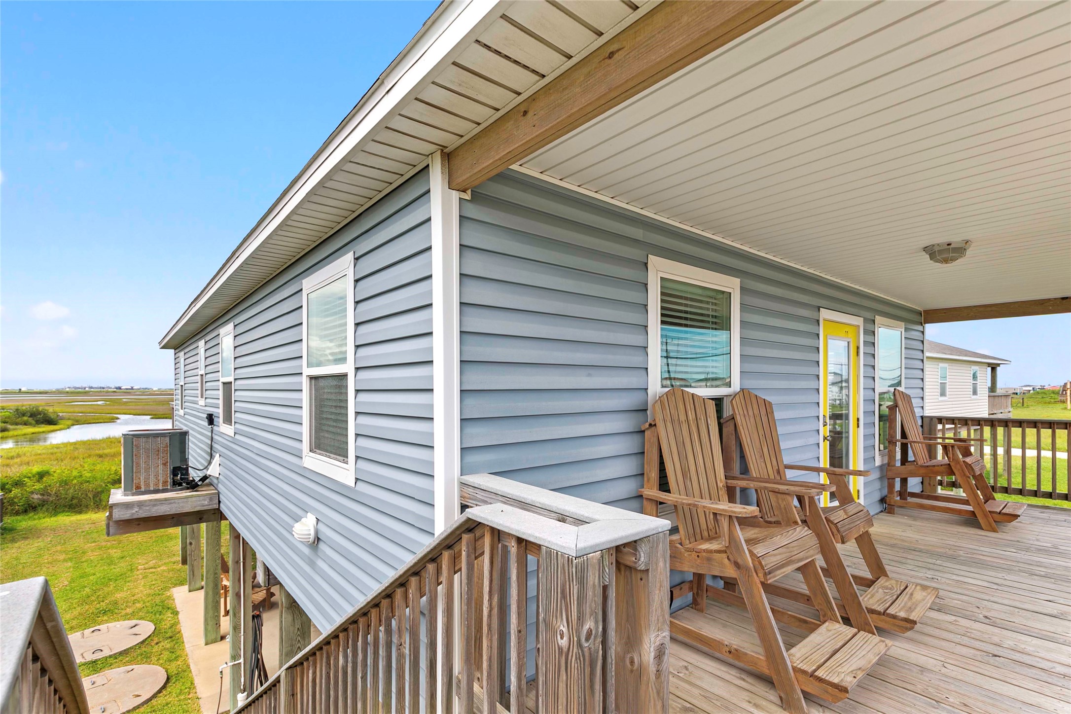 757 Bluewater Highway Surfside Beach, TX 77541 - Photo 35 of 44 a view of a patio with table and chairs with wooden floor and fence