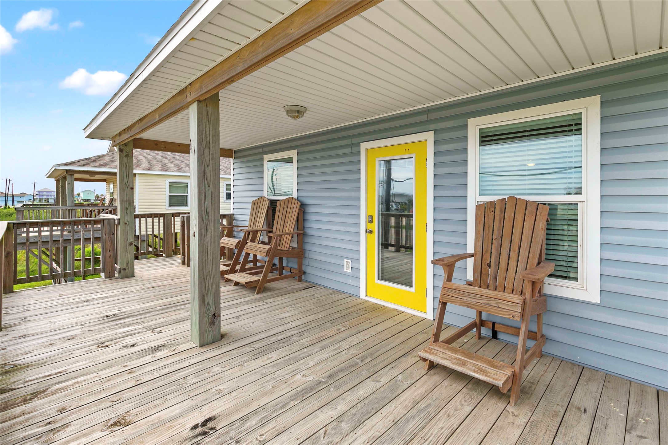 757 Bluewater Highway Surfside Beach, TX 77541 - Photo 4 of 44 a view of a patio with table and chairs wooden floor and fence