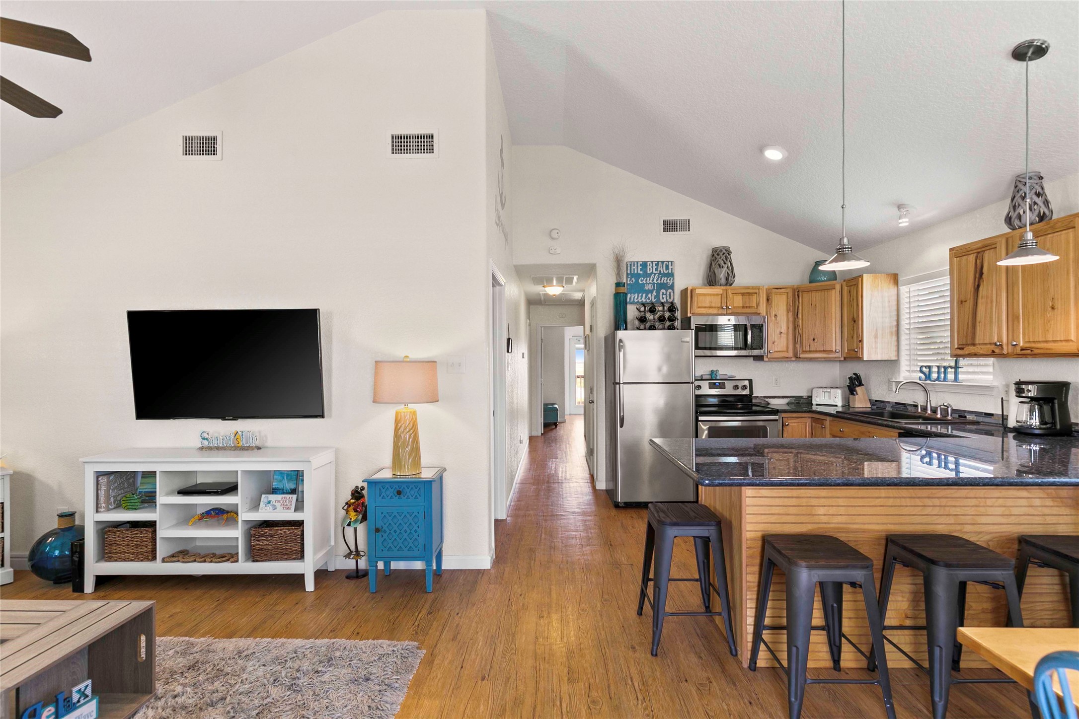 757 Bluewater Highway Surfside Beach, TX 77541 - Photo 9 of 44 a living room with stainless steel appliances furniture a flat screen tv and kitchen view
