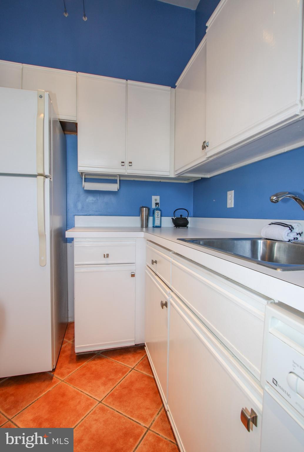 1434 Potomac Avenue Southeast, Unit 5 Washington, DC 20003 - Photo 13 of 38 a kitchen with granite countertop white cabinets and white appliances