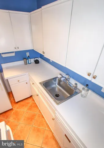 a kitchen with a sink and a refrigerator