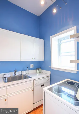 a kitchen with a sink cabinets and window