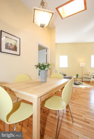a dining room with furniture and wooden floor