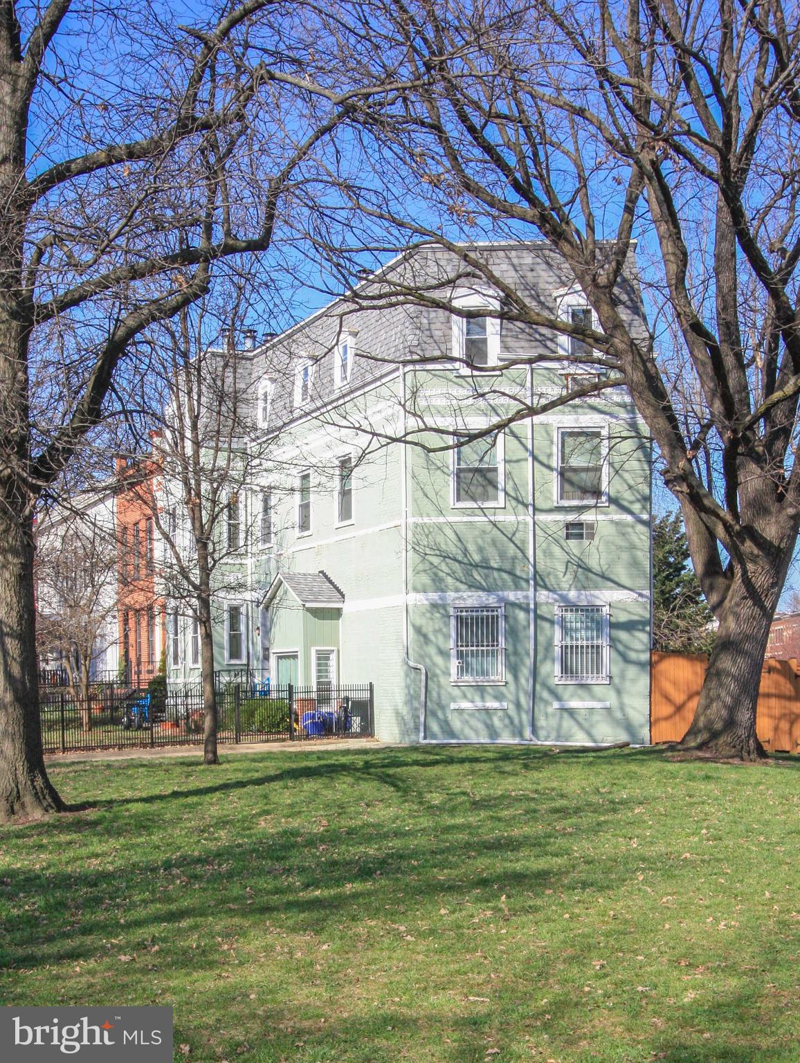 1434 Potomac Avenue Southeast, Unit 5 Washington, DC 20003 - Photo 33 of 38 a view of a white building with a big yard and large trees