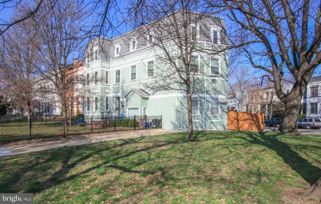 a front view of a building with a yard