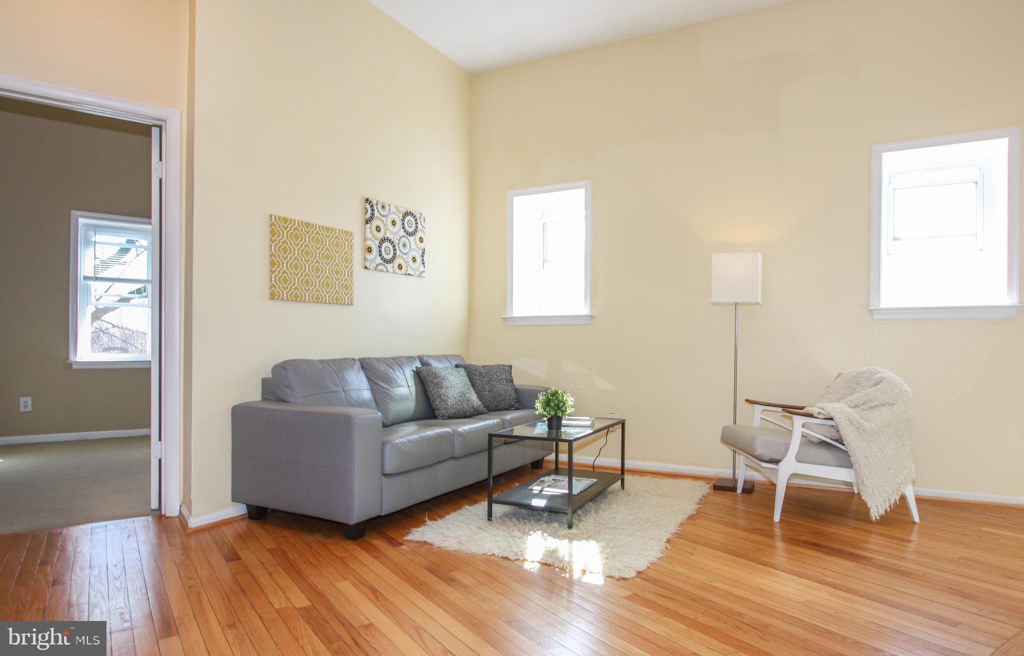 1434 Potomac Avenue Southeast, Unit 5 Washington, DC 20003 - Photo 5 of 38 a living room with couch and a wooden floor