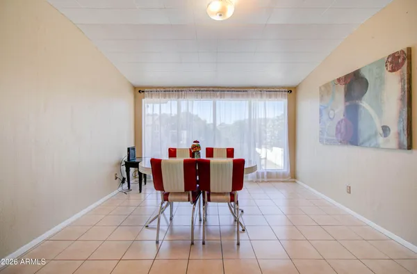 a dining room with furniture and window