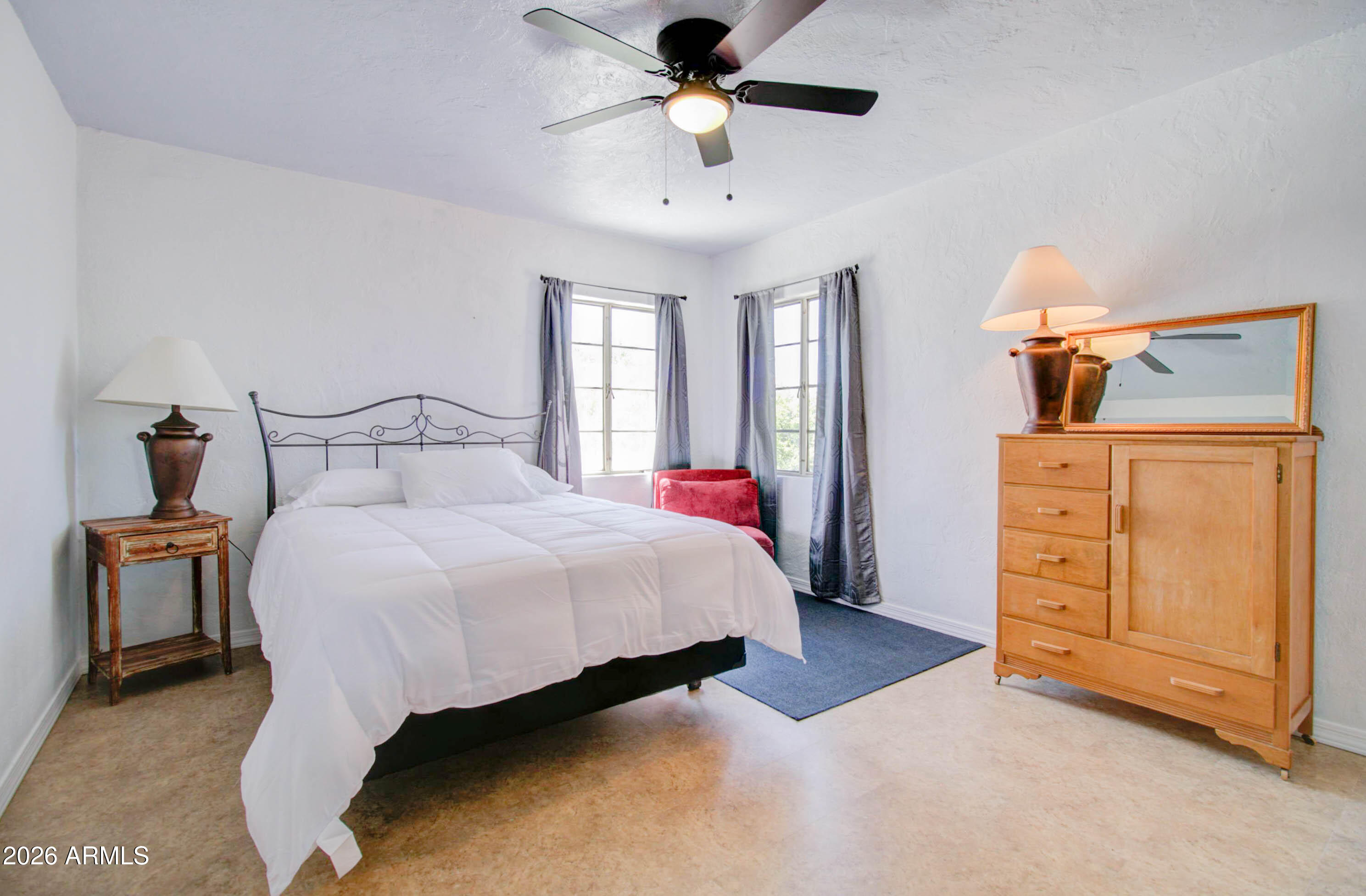 877 East Sycamore Street Globe, AZ 85501 - Photo 15 of 42 a bedroom with a bed and a chandelier