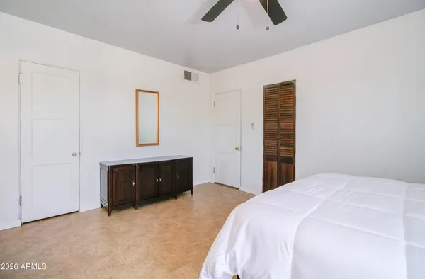 a bedroom with a bed and a dresser
