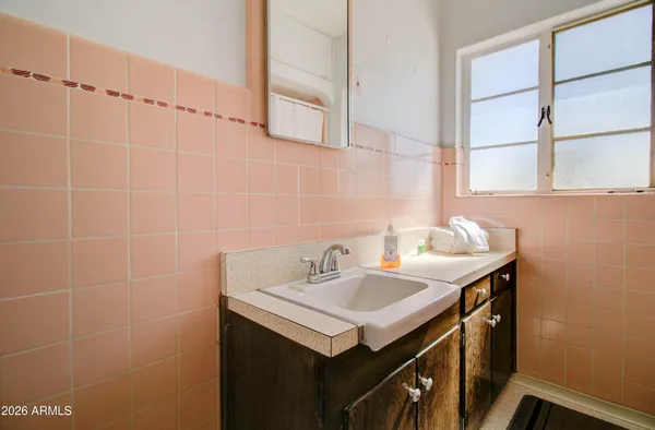 a bathroom with a sink and a mirror