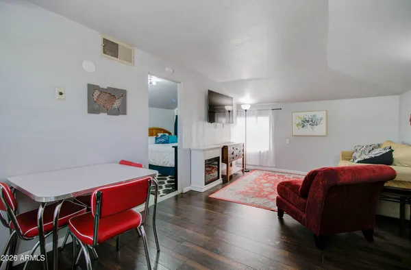 a living room with furniture a flat screen tv and a table