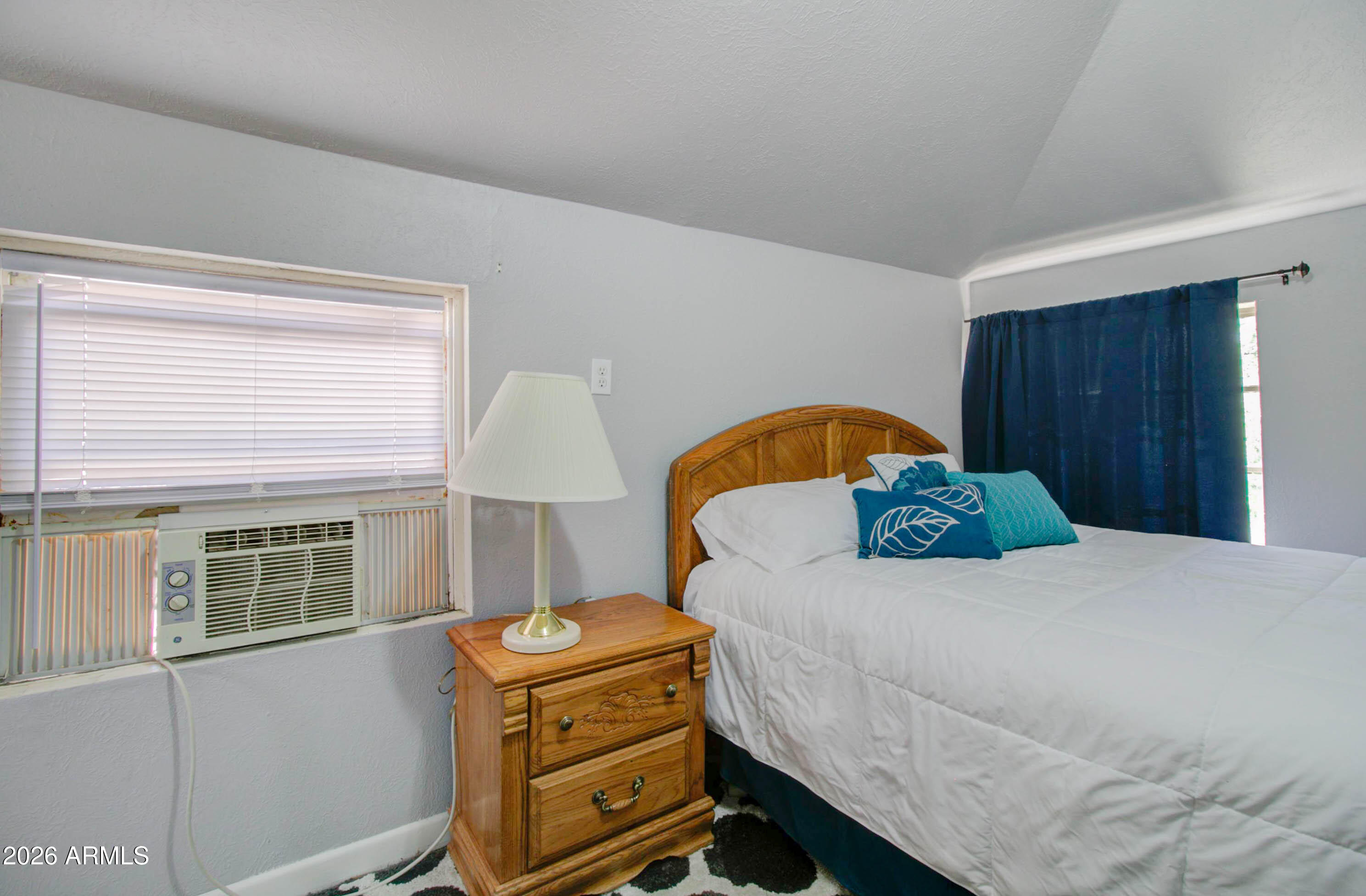 877 East Sycamore Street Globe, AZ 85501 - Photo 27 of 42 a bedroom with a bed and wooden floor