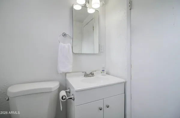 a bathroom with a sink a toilet and a mirror
