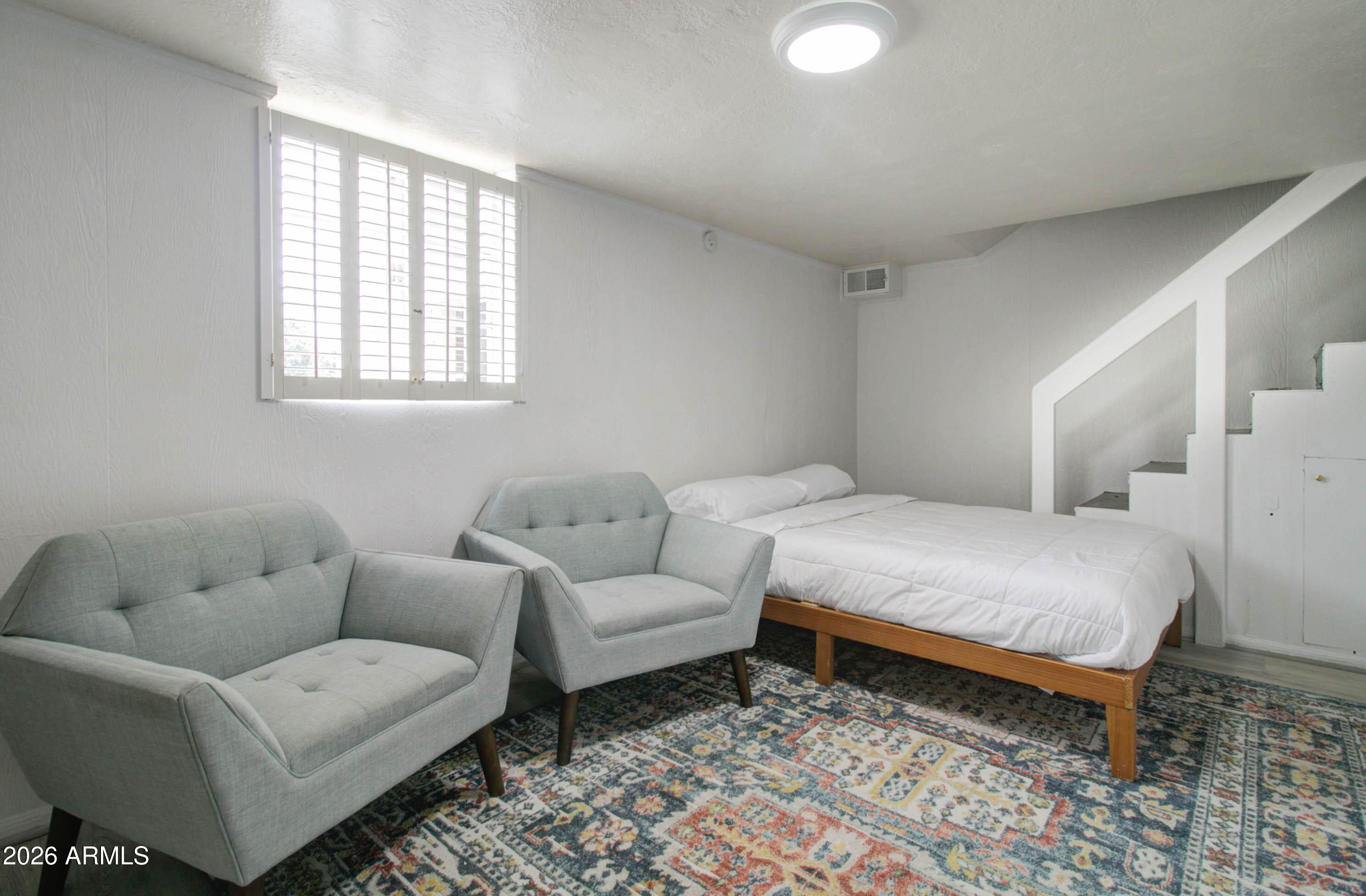 877 East Sycamore Street Globe, AZ 85501 - Photo 35 of 42 a bedroom with furniture and a rug