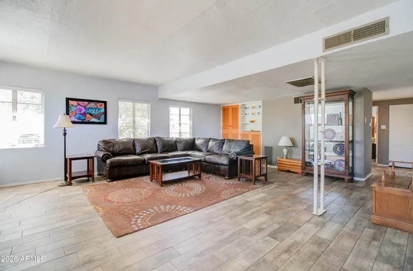 a living room with furniture window and wooden floor