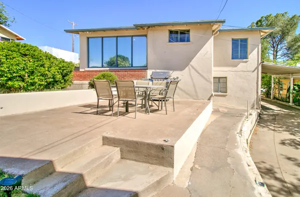 a view of a patio with table and chairs with wooden floor and plants