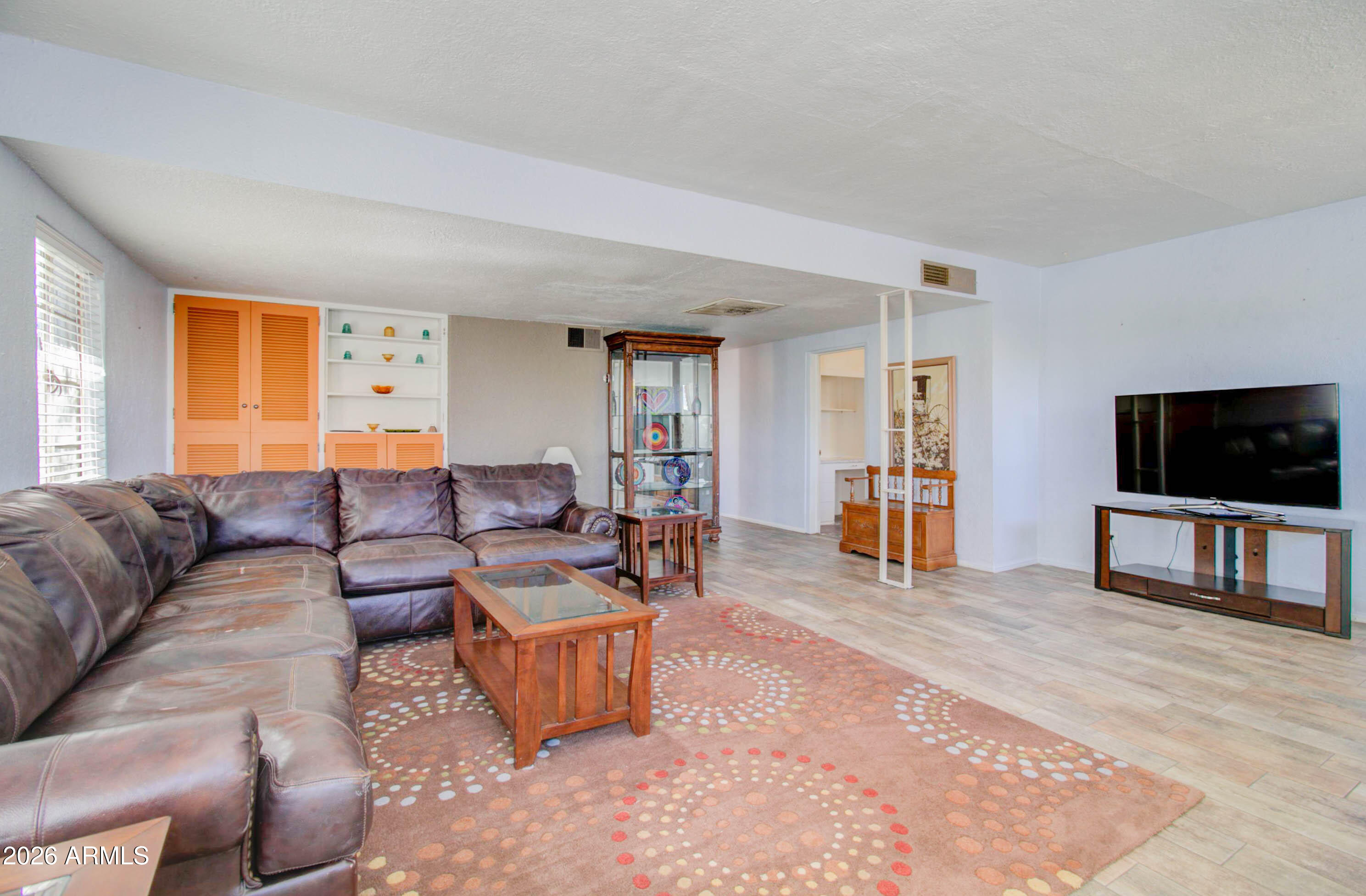 877 East Sycamore Street Globe, AZ 85501 - Photo 5 of 42 a living room with furniture and a flat screen tv