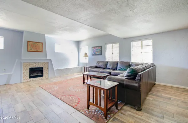 a living room with furniture and a fireplace