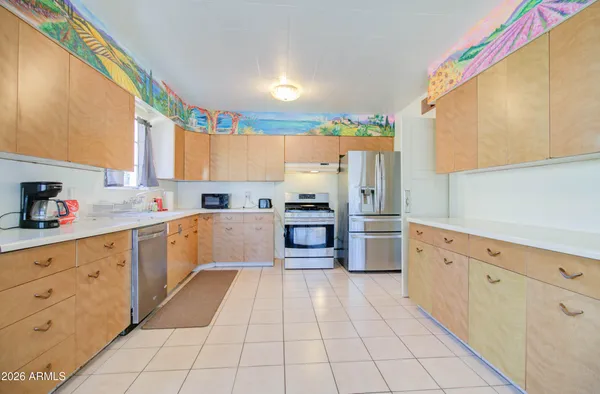 a kitchen with stainless steel appliances a sink counter space and a window