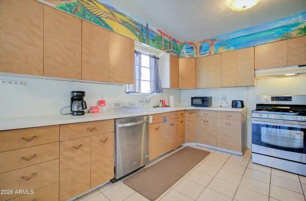a kitchen with cabinets and appliances