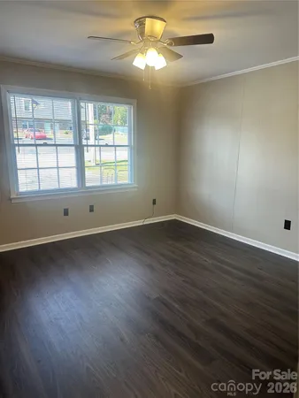 a view of an empty room with wooden floor