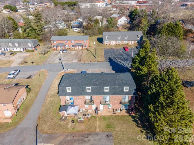 a view of a house with a yard and potted plants