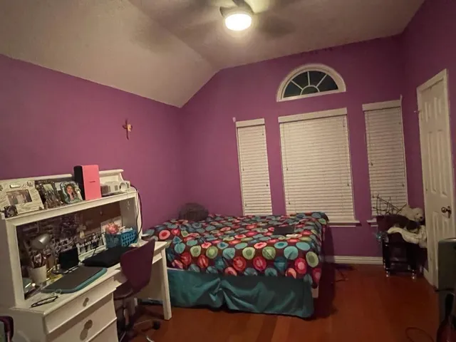 a bedroom with a bed and a potted plant