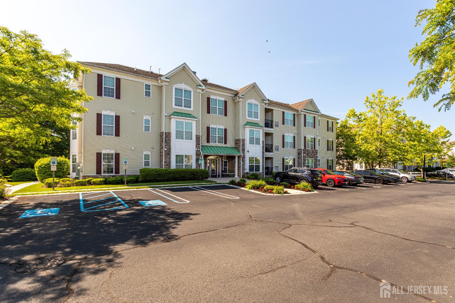 a view of a building with cars parked on the road