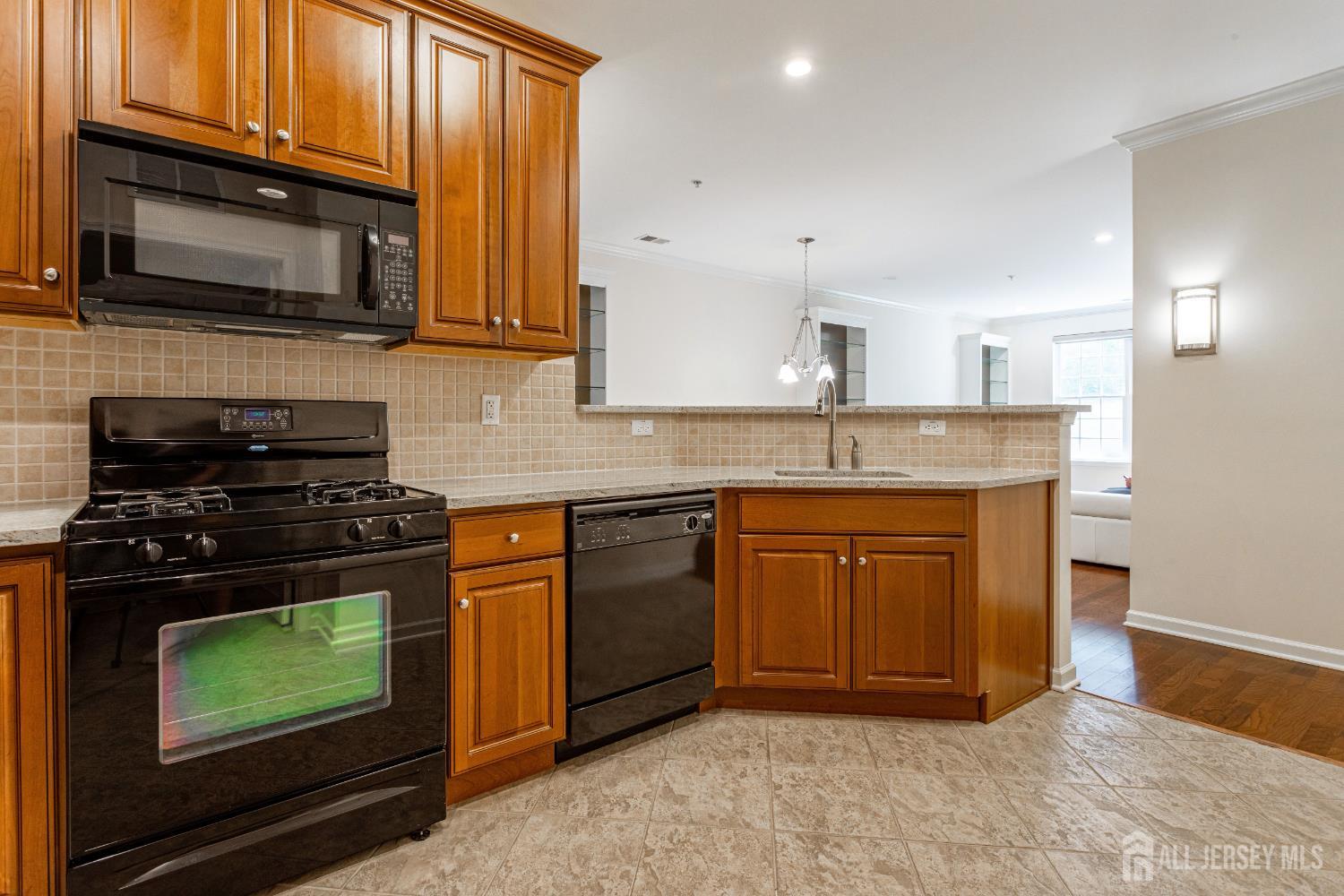 40 Azalea Drive Old Bridge, NJ 08857 - Photo 13 of 35 a kitchen with stainless steel appliances granite countertop wooden cabinets stove top oven and sink