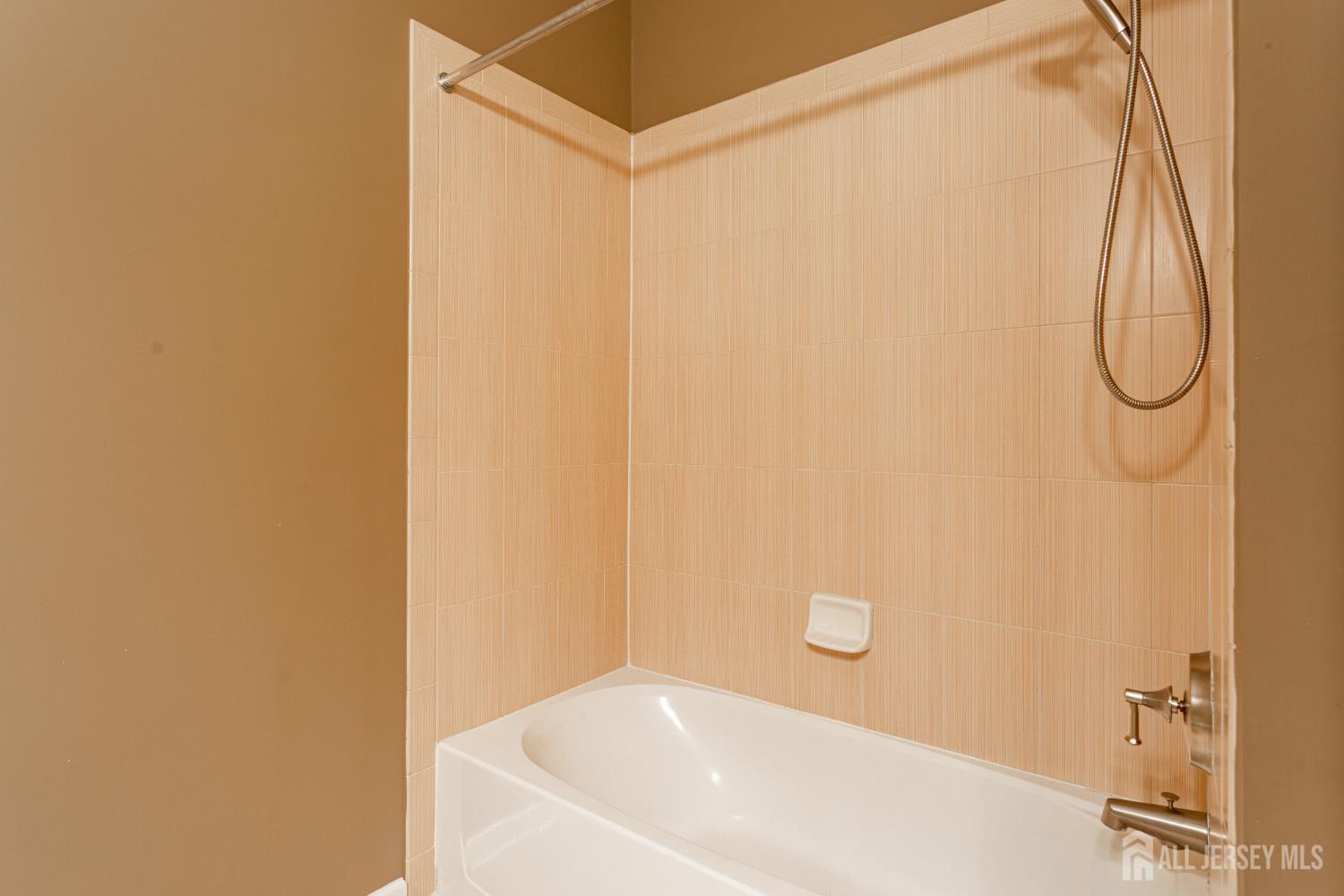 40 Azalea Drive Old Bridge, NJ 08857 - Photo 26 of 35 a bathroom with a white bath tub and a shower curtain