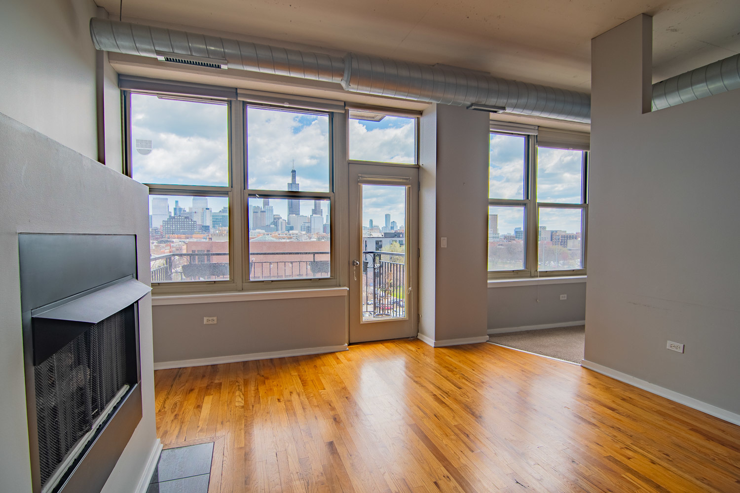 6 South Laflin Street, Unit 808 Chicago, IL 60607 - Photo 4 of 13 a view of an empty room with wooden floor and a window