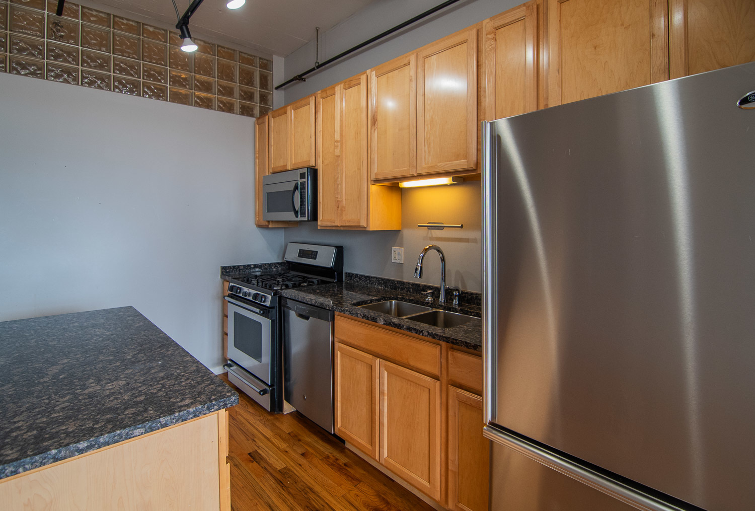 6 South Laflin Street, Unit 808 Chicago, IL 60607 - Photo 5 of 13 a kitchen with stainless steel appliances granite countertop a refrigerator and a stove