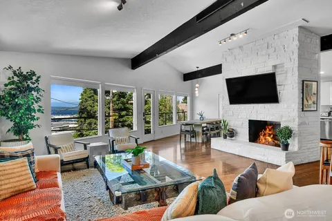 a living room with fireplace furniture and a flat screen tv