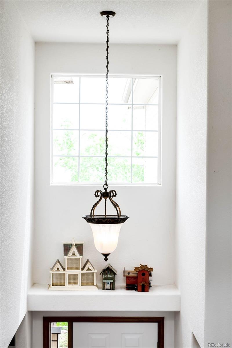 6549 Poppy Street Arvada, CO 80007 - Photo 14 of 33 a view of a room with a table and chandelier