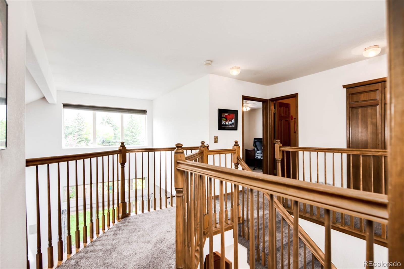 6549 Poppy Street Arvada, CO 80007 - Photo 15 of 33 a view of staircase with black white walls
