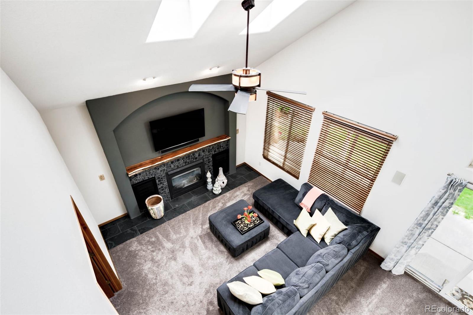 6549 Poppy Street Arvada, CO 80007 - Photo 16 of 33 a living room with furniture and a flat screen tv