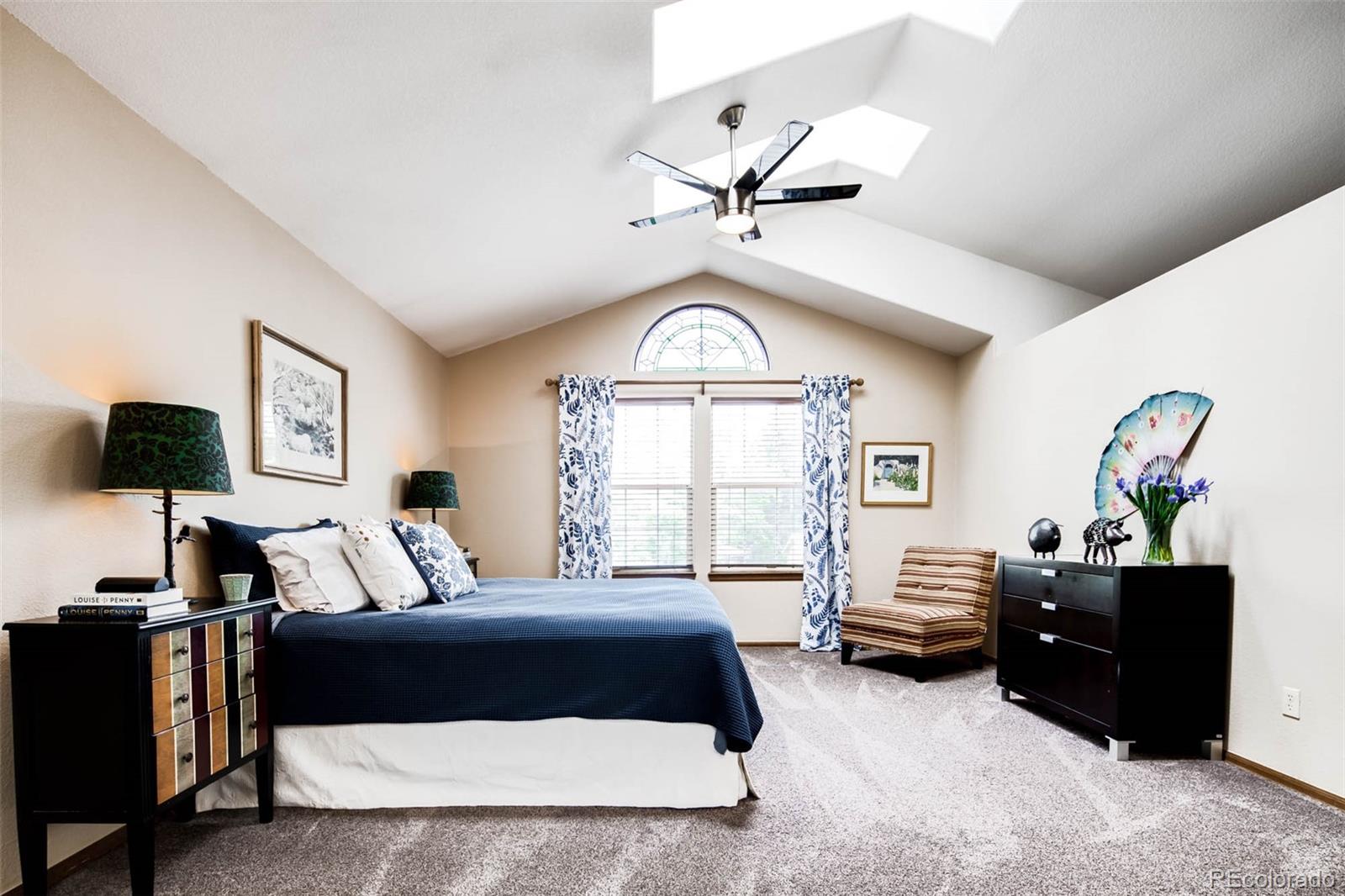 6549 Poppy Street Arvada, CO 80007 - Photo 17 of 33 a spacious bedroom with a bed window and couch
