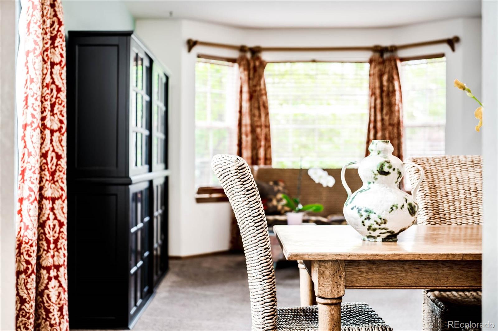6549 Poppy Street Arvada, CO 80007 - Photo 2 of 33 a view of a dining room with furniture and a window