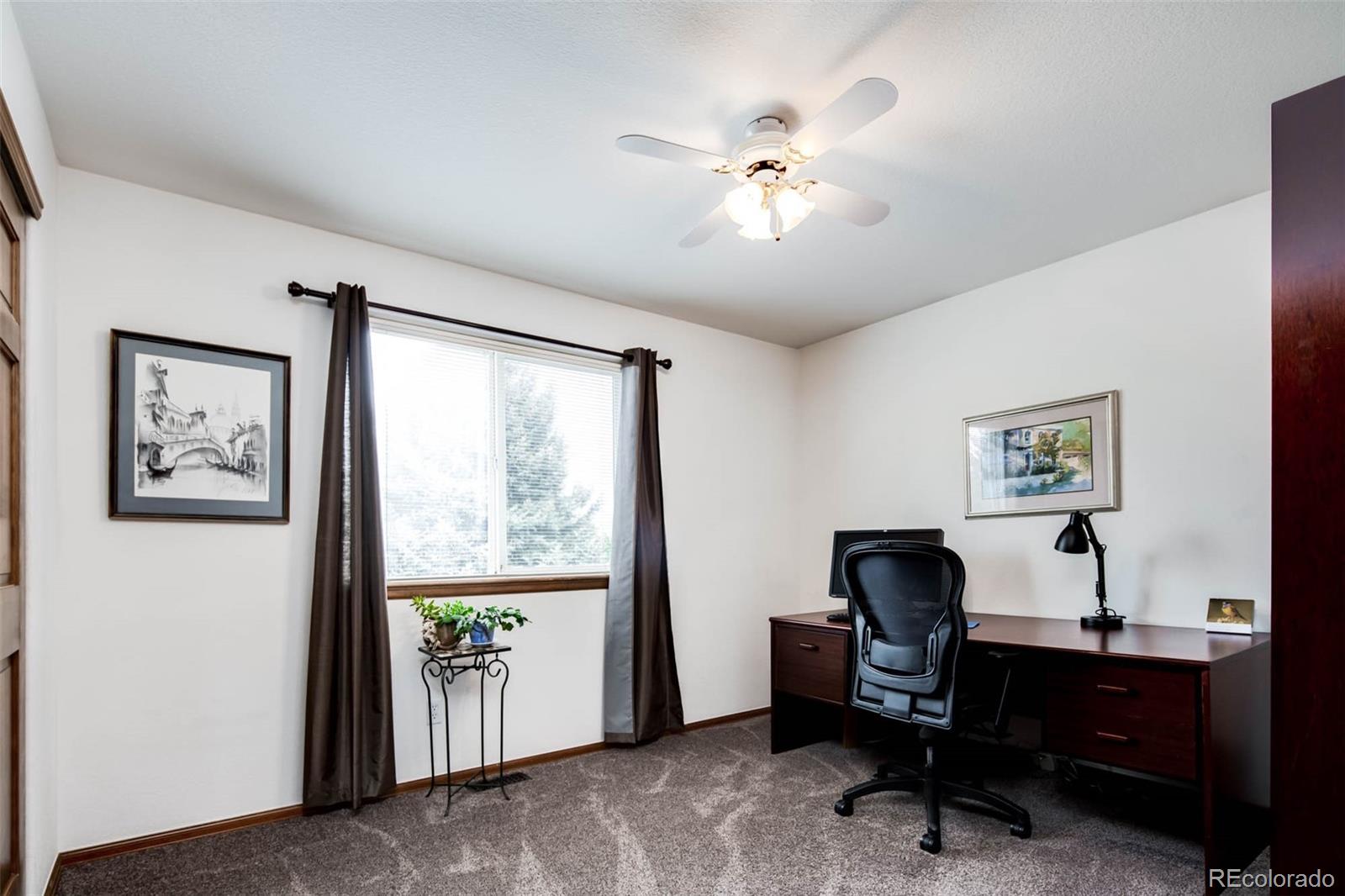 6549 Poppy Street Arvada, CO 80007 - Photo 22 of 33 a view of a workspace with furniture and a window