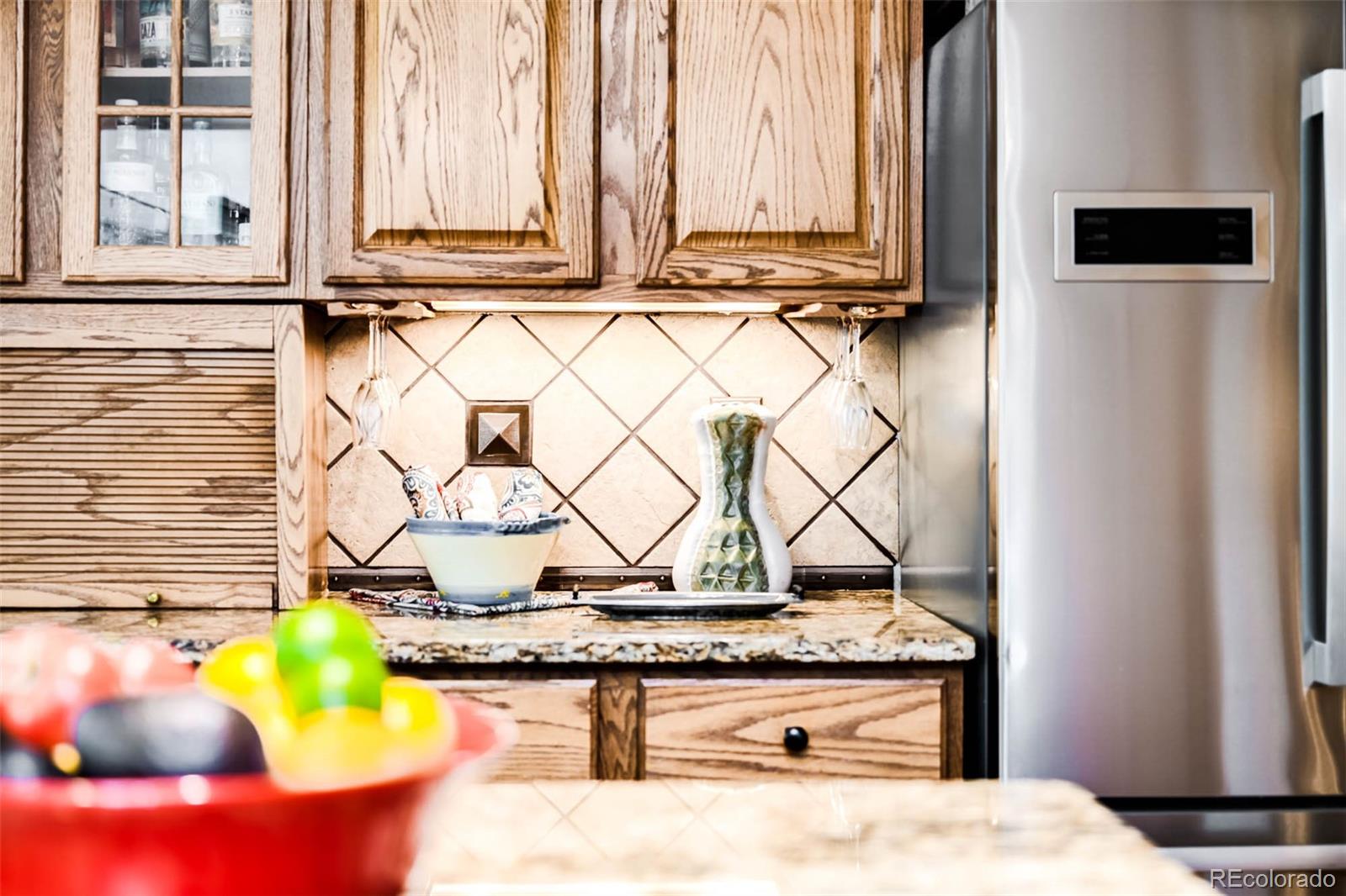6549 Poppy Street Arvada, CO 80007 - Photo 9 of 33 a bathroom with a granite countertop sink and a mirror