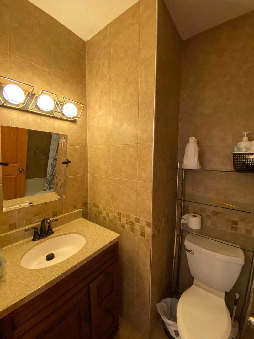 723 West 31st Street, Unit 2 Chicago, IL 60616 - Photo 15 of 21 a bathroom with a sink and mirror with toilet
