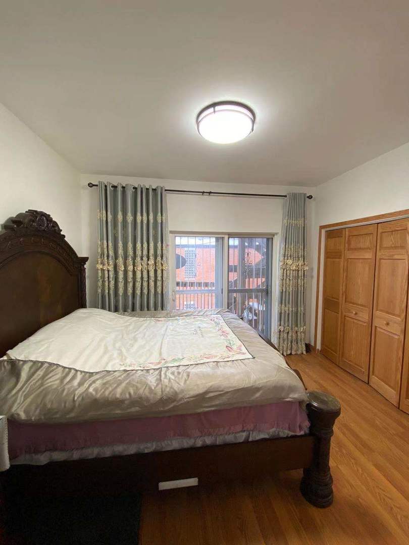 723 West 31st Street, Unit 2 Chicago, IL 60616 - Photo 18 of 21 a bedroom with a bed and wooden floor
