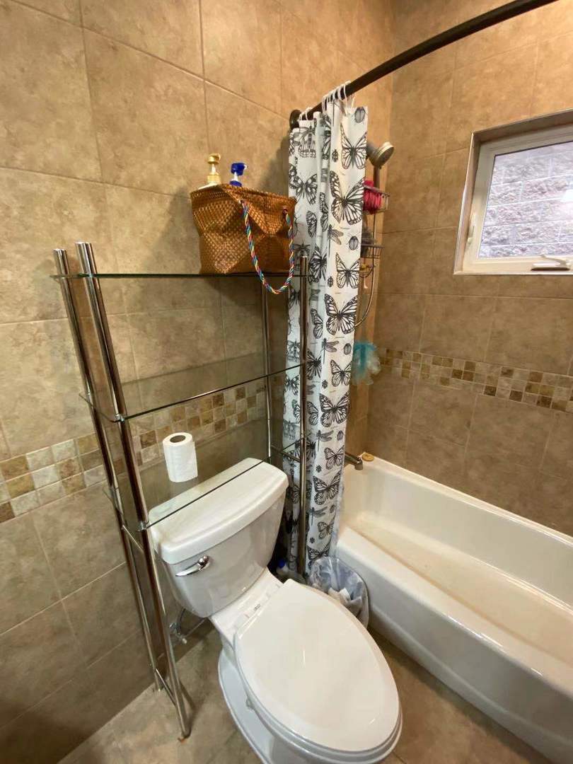 723 West 31st Street, Unit 2 Chicago, IL 60616 - Photo 20 of 21 a white toilet sitting next to a bath tub and shower