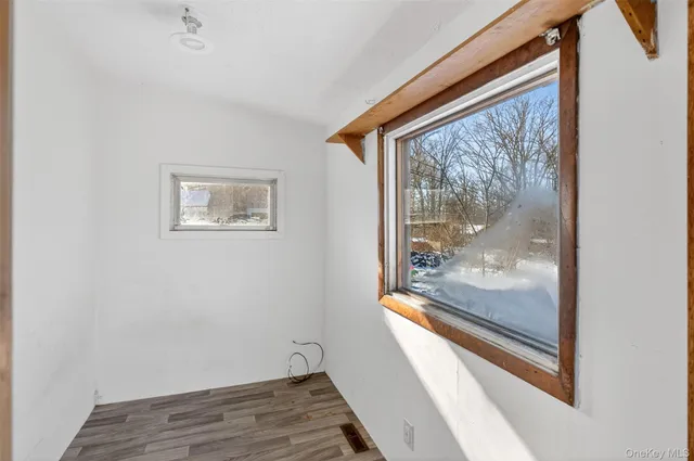 a view of a hallway with wooden floor and a floor to ceiling window