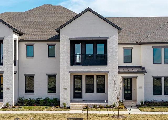 a view of a white house with large windows