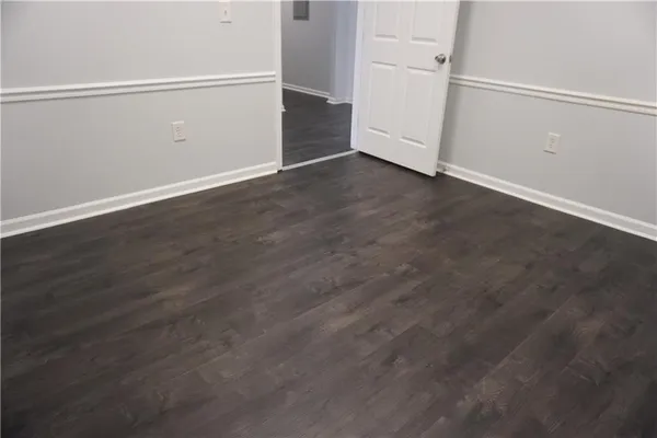 an empty room with wooden floor